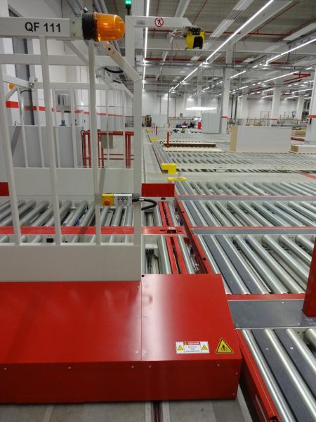 Detailansicht eines Pufferspeichers mit Querförderwagen und kreuzenden Rollenbahnen. Die Förderelemente sind innerhalb des Materialflusses miteinander verbunden.