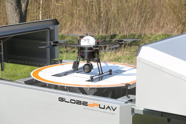 Drohnenhangar Skyport mit Drohne auf der Startplattform und geöffneter Ladebox.