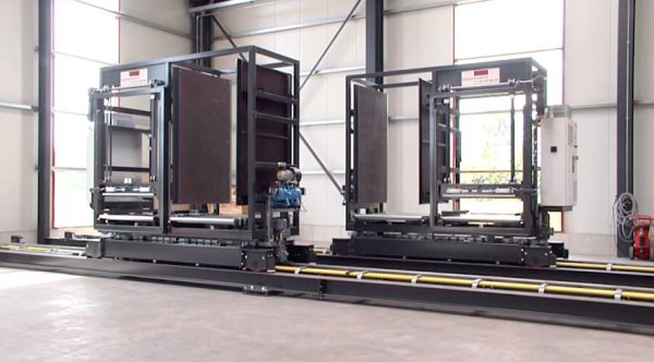 Overall view of two rail vehicles with material carriers in an upright position on a floor-flush rail system. 
