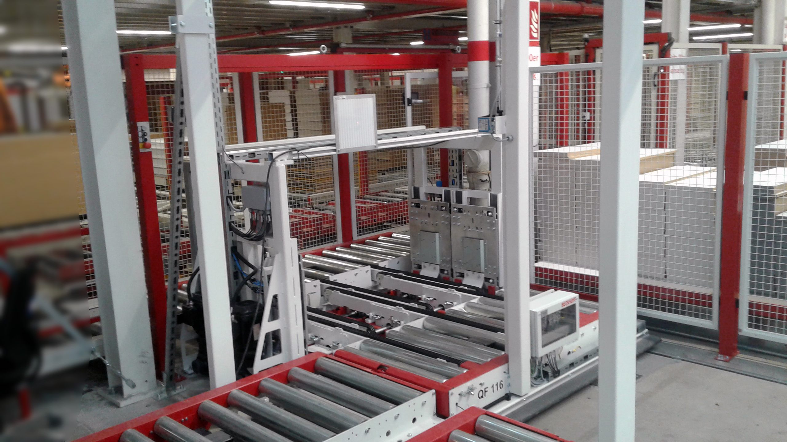 Industrial orientation station with conveyor rollers and a metal frame in a warehouse 