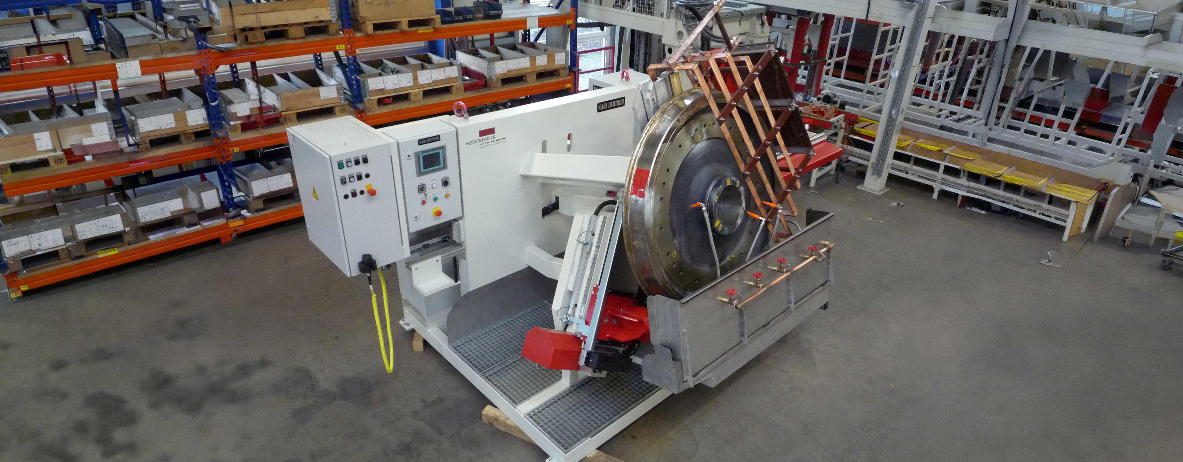 An angled view of a crack test bench with a large roller bearing ring clamped in place. The workpiece is in the test position within the clamping and rotating device.